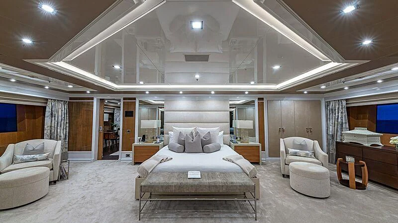 a large bedroom with a bed and a desk aboard ANDIAMO Yacht for Sale