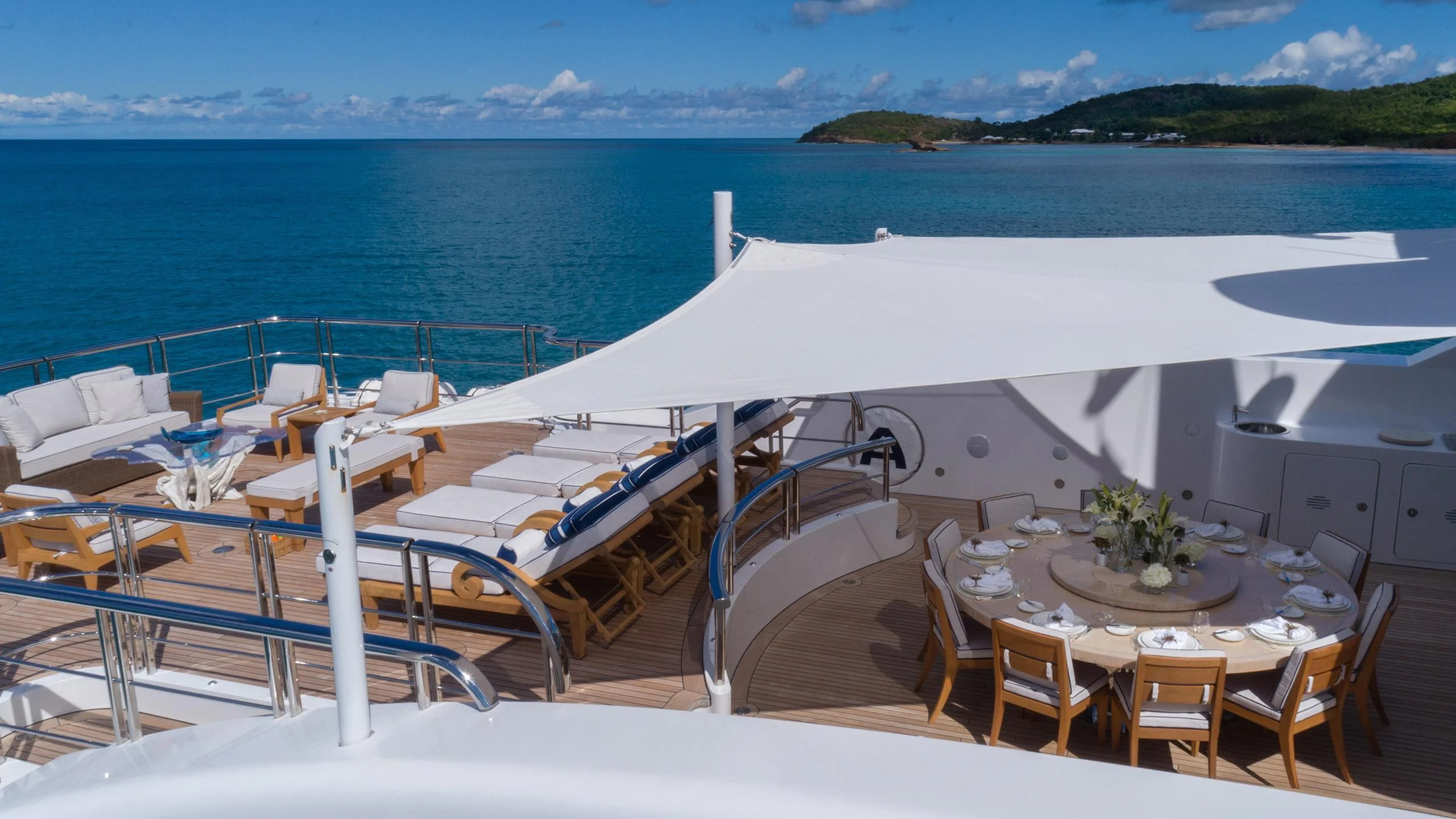 a room with chairs and tables on it by the water aboard ANDIAMO Yacht for Sale