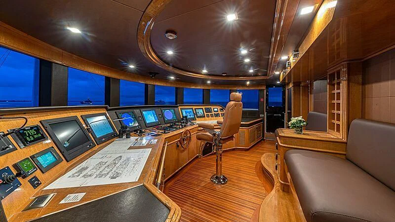 a room with a couch and a table with a large screen aboard ANDIAMO Yacht for Sale