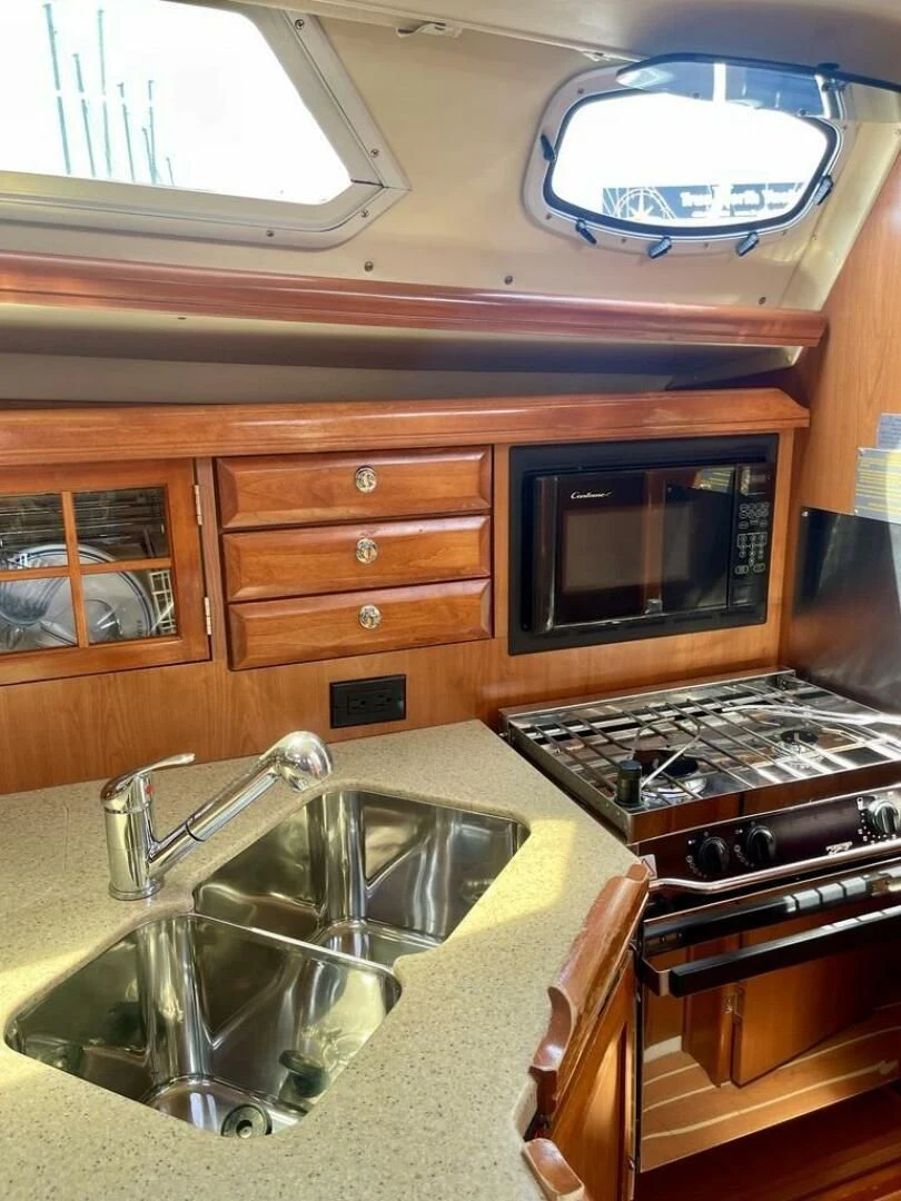 a kitchen with wooden cabinets aboard ANDIAMO Yacht for Sale