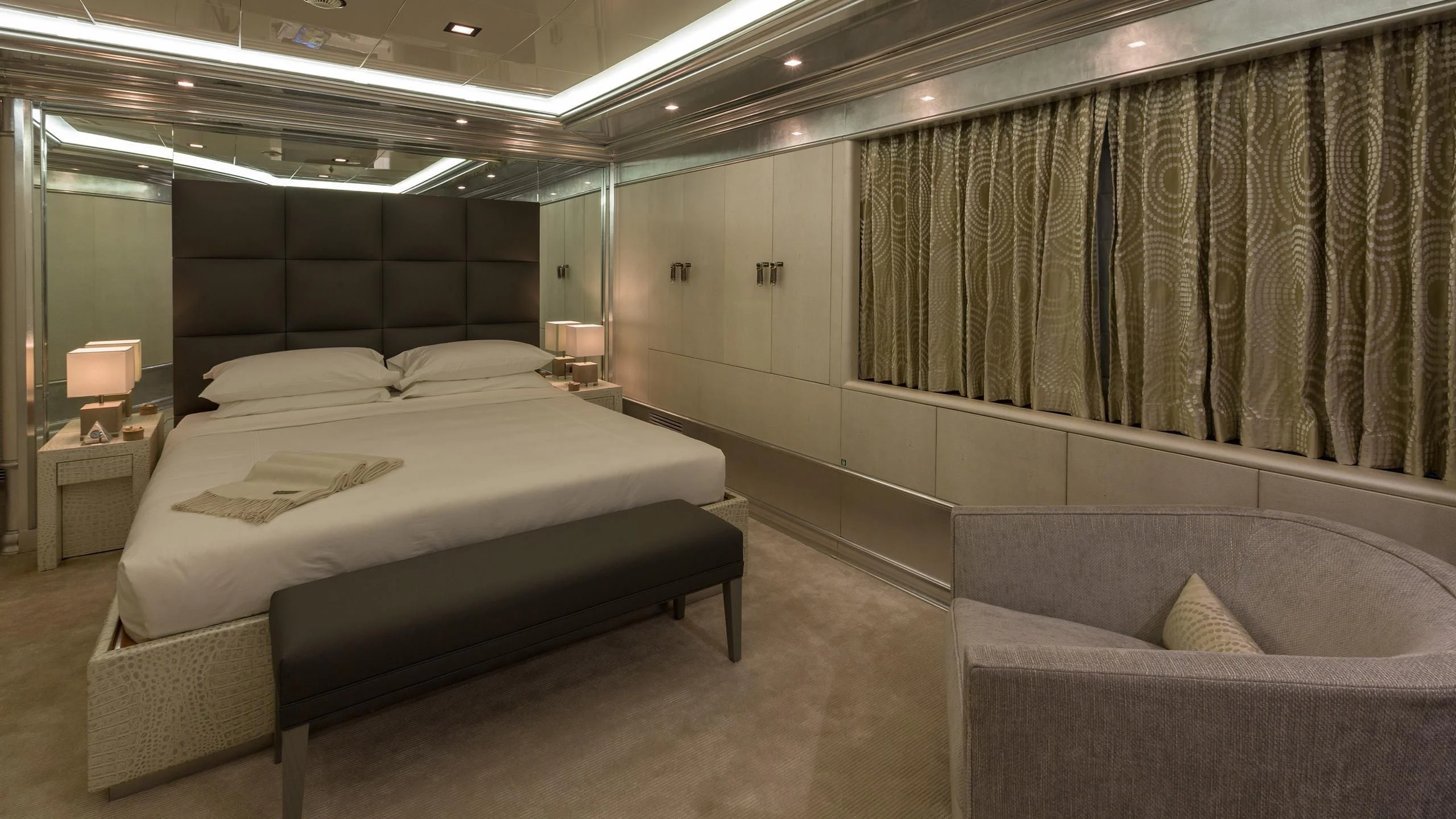 a room with a bed and a couch aboard ANDIAMO Yacht for Sale