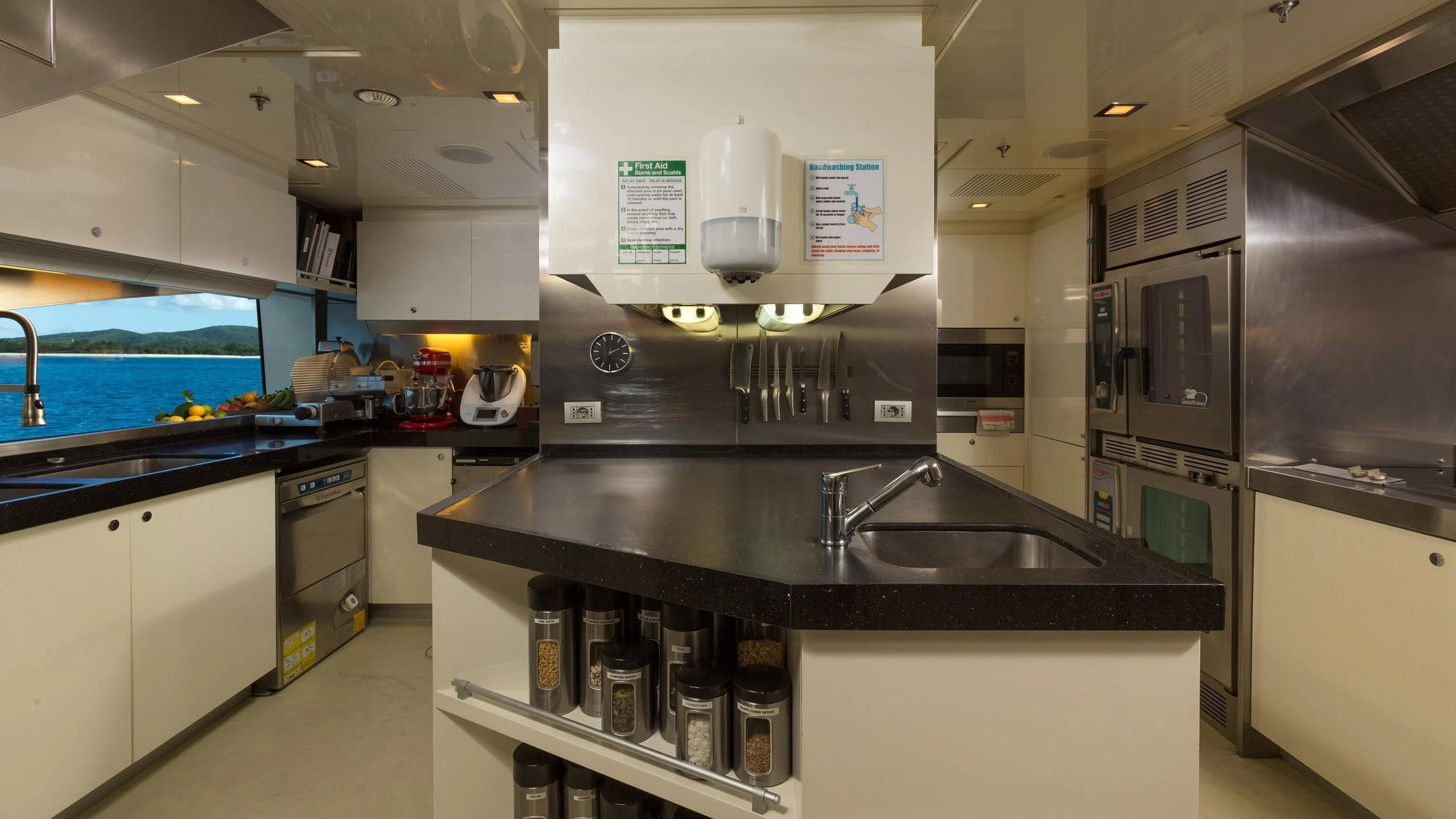 a kitchen with a sink and a microwave aboard ANDIAMO Yacht for Sale