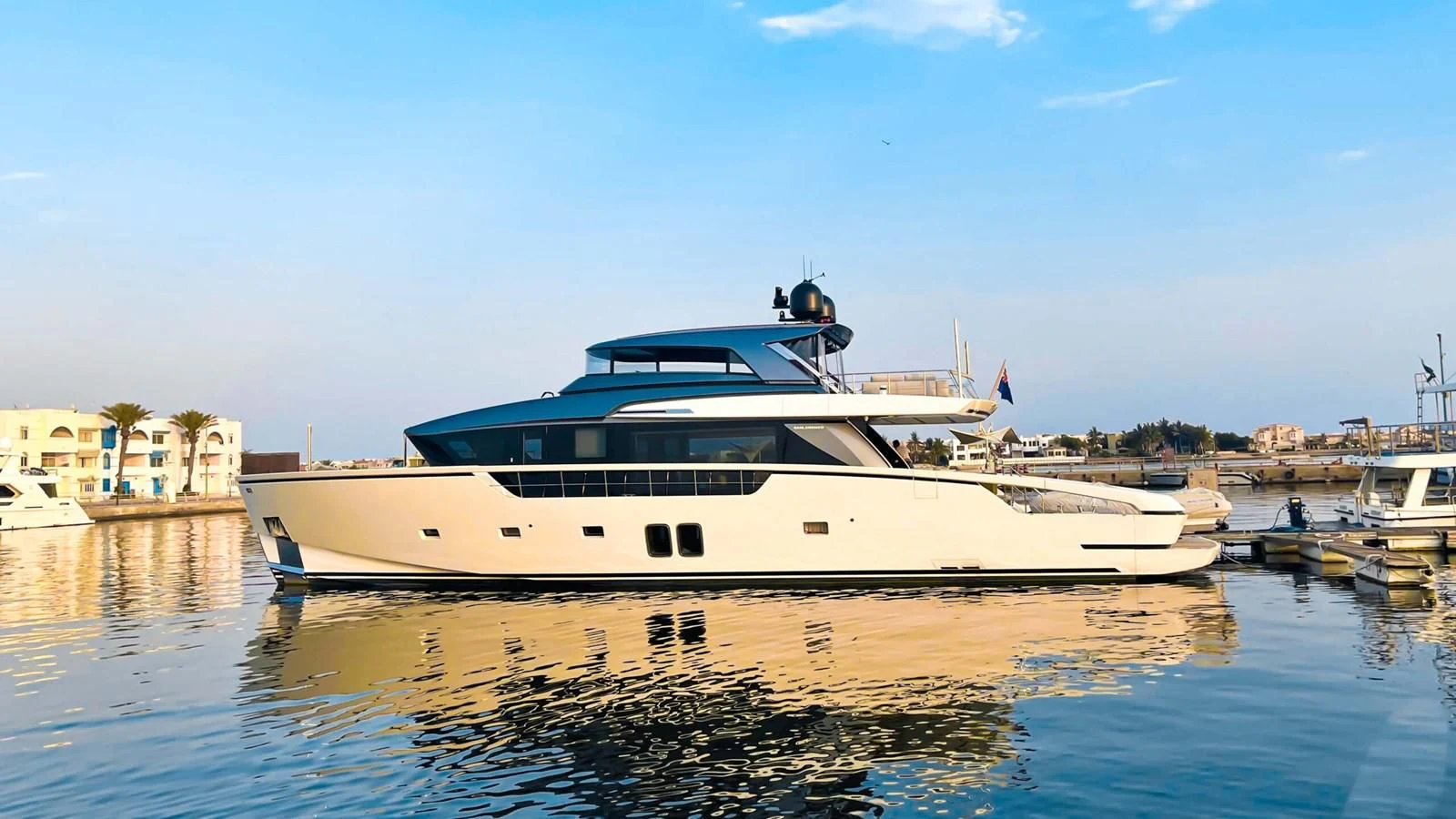 a large white boat in a harbor aboard 2020 SANLORENZO SX88 #43 Yacht for Sale