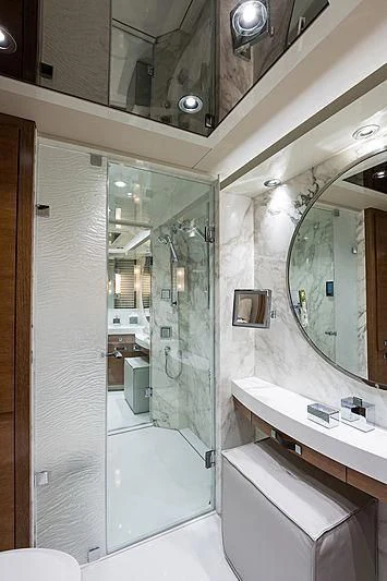 a bathroom with a glass shower aboard HAT TRICK Yacht for Sale