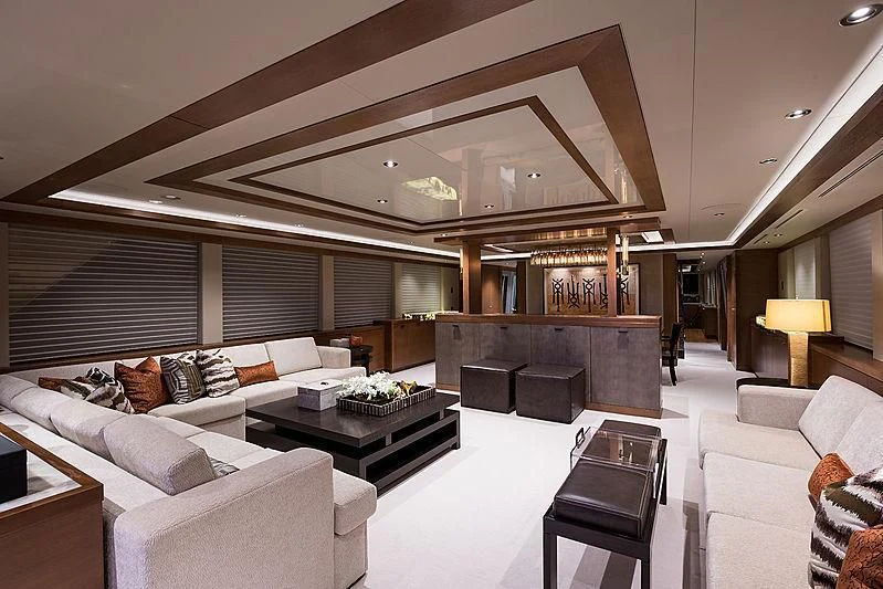 a living room with a large white couch and a large fireplace aboard HAT TRICK Yacht for Sale