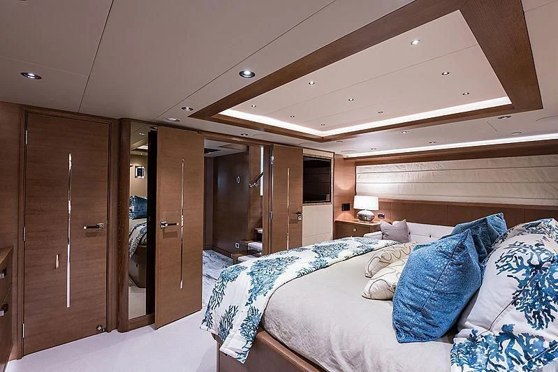 a bedroom with a bed and a closet aboard HAT TRICK Yacht for Sale