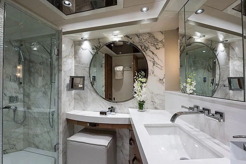 a bathroom with a glass shower aboard HAT TRICK Yacht for Sale