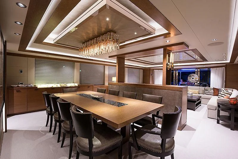 a large room with a table and chairs aboard HAT TRICK Yacht for Sale