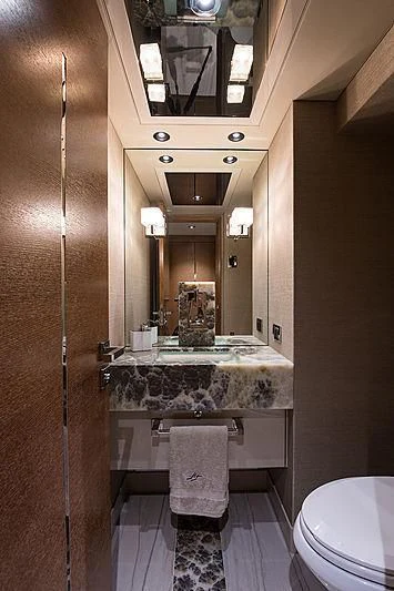 a bathroom with a large mirror aboard HAT TRICK Yacht for Sale