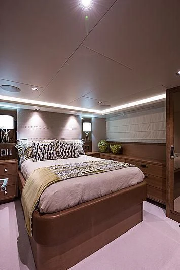 a large bedroom with a large bed aboard HAT TRICK Yacht for Sale