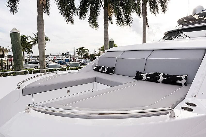 a white boat with a black and white object on the front aboard HAT TRICK Yacht for Sale