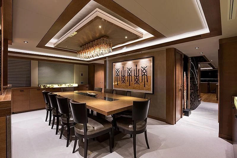 a room with a table and chairs aboard HAT TRICK Yacht for Sale