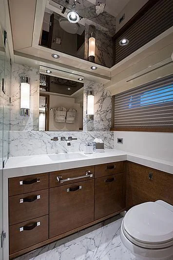 a bathroom with a large mirror aboard HAT TRICK Yacht for Sale