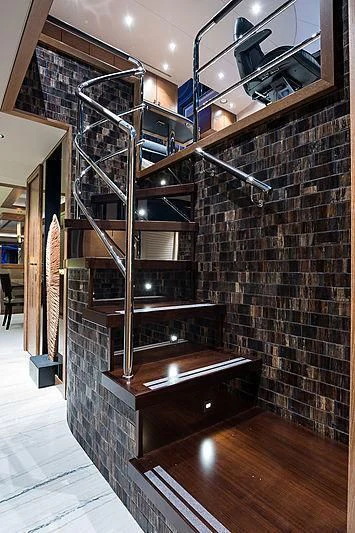 a room with a brick wall and a shelf with objects on it aboard HAT TRICK Yacht for Sale