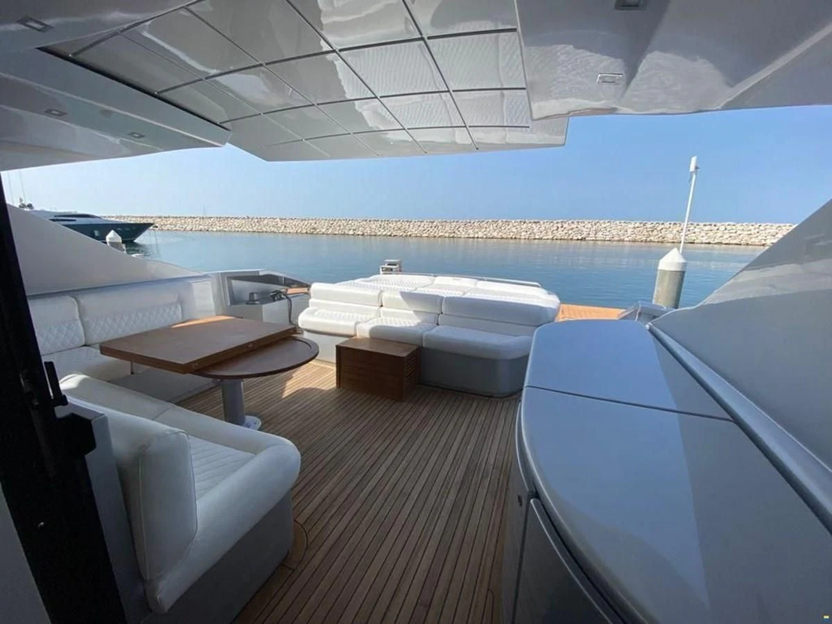 a room with a table and chairs aboard PERSHING 72 Yacht for Sale