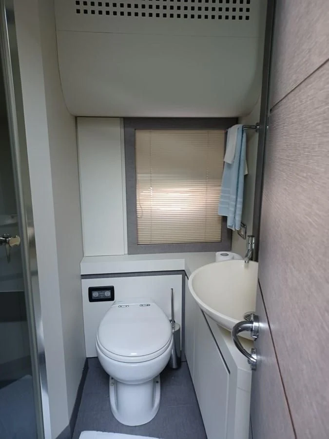 a small bathroom with a toilet and sink aboard PERSHING 72 Yacht for Sale