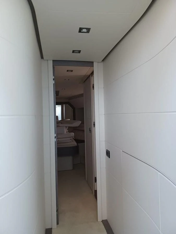 a hallway with a toilet and a sink aboard PERSHING 72 Yacht for Sale