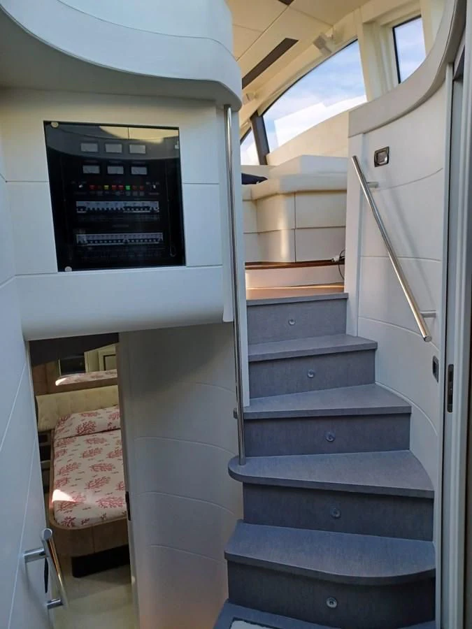 a staircase with a sign on the wall aboard PERSHING 72 Yacht for Sale