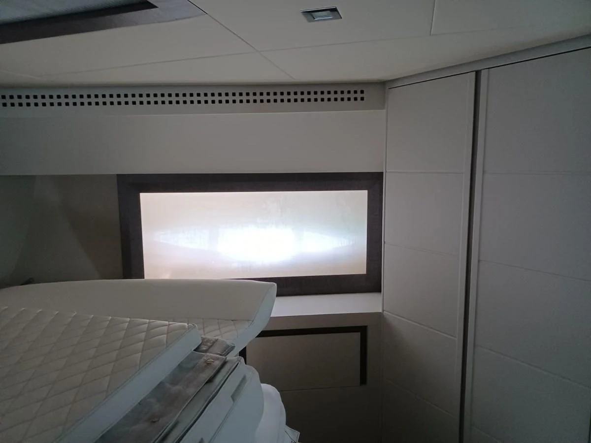 a white room with a television aboard PERSHING 72 Yacht for Sale