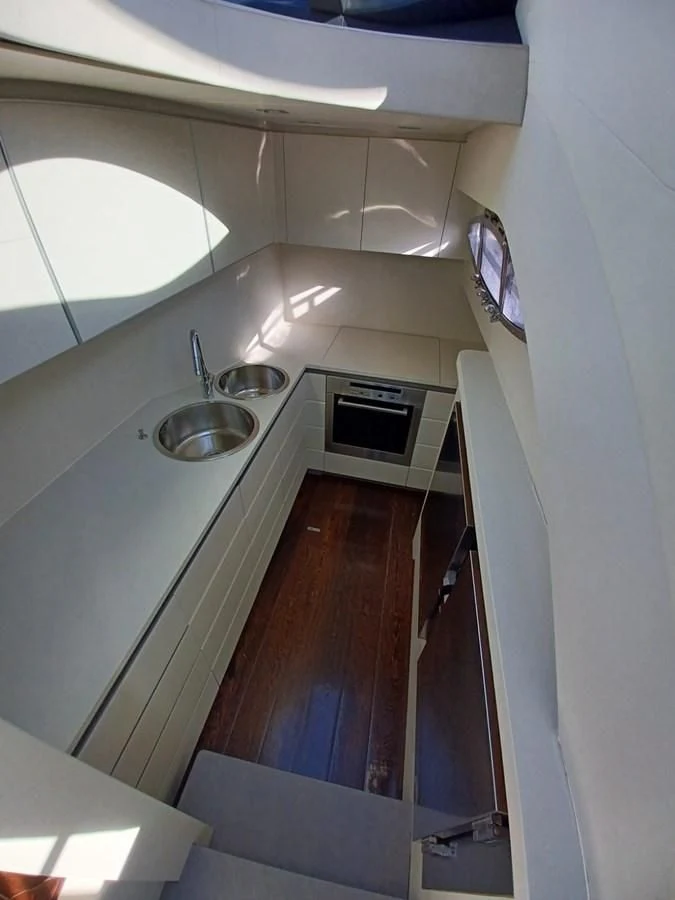 a kitchen with a sink and a microwave aboard PERSHING 72 Yacht for Sale