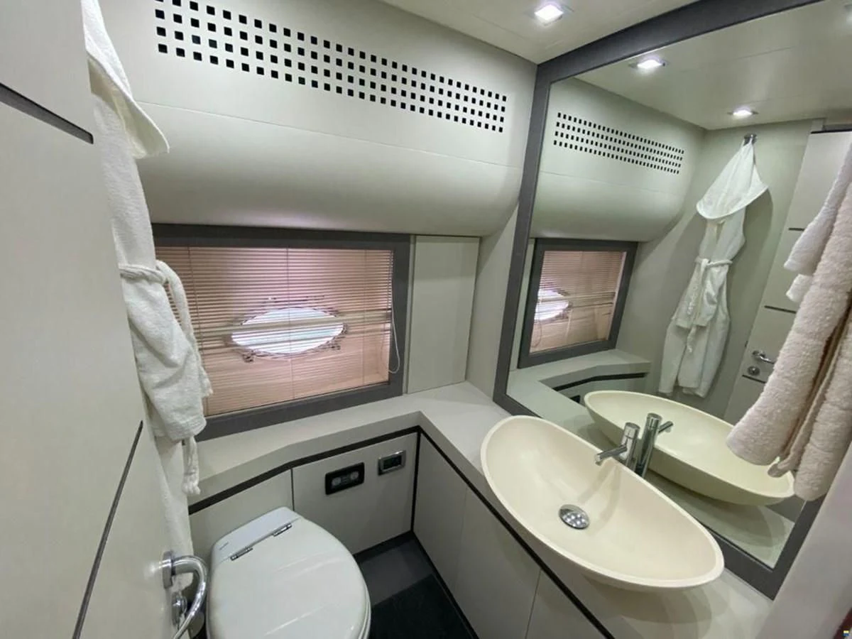 a bathroom with a large mirror aboard PERSHING 72 Yacht for Sale