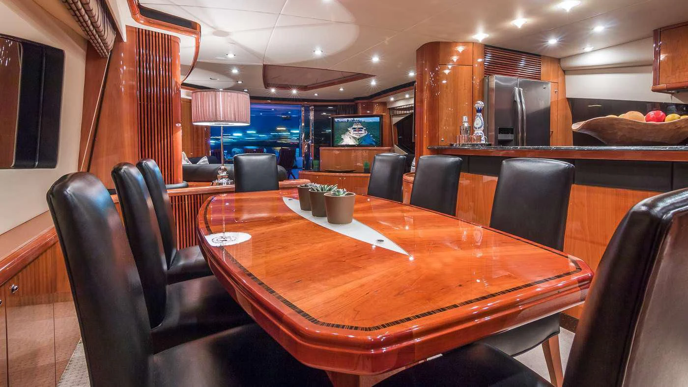 a table with chairs around it aboard SS ARTS Yacht for Sale