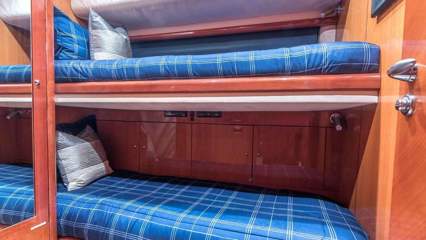 a bed with a blue sheet aboard SS ARTS Yacht for Sale
