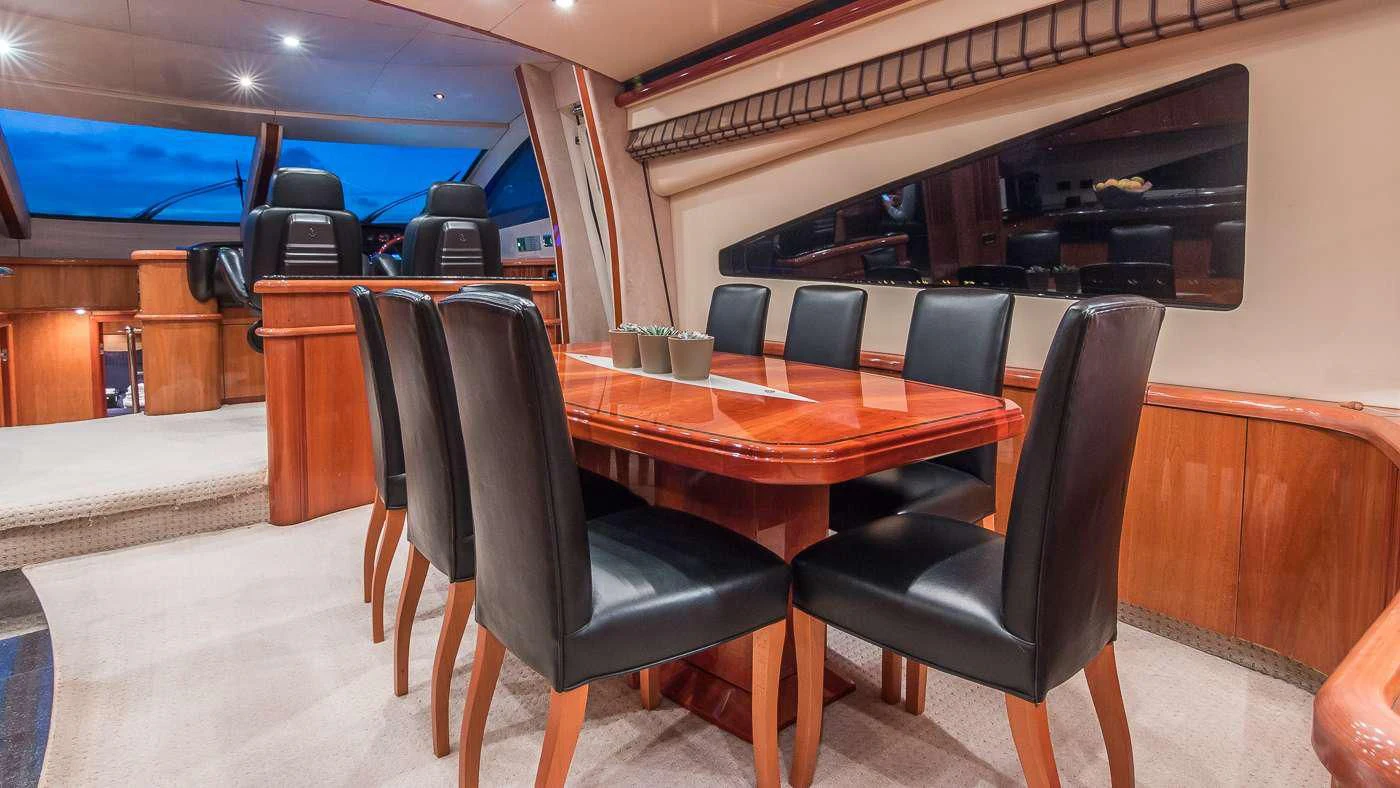 a table and chairs in a room aboard SS ARTS Yacht for Sale