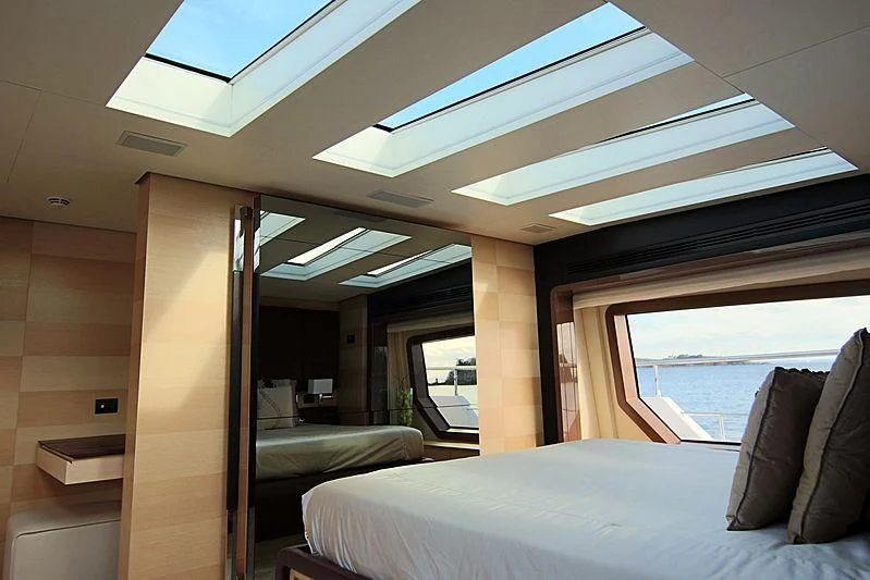 a room with a bed and a window aboard ESTEL OF IBIZA Yacht for Sale
