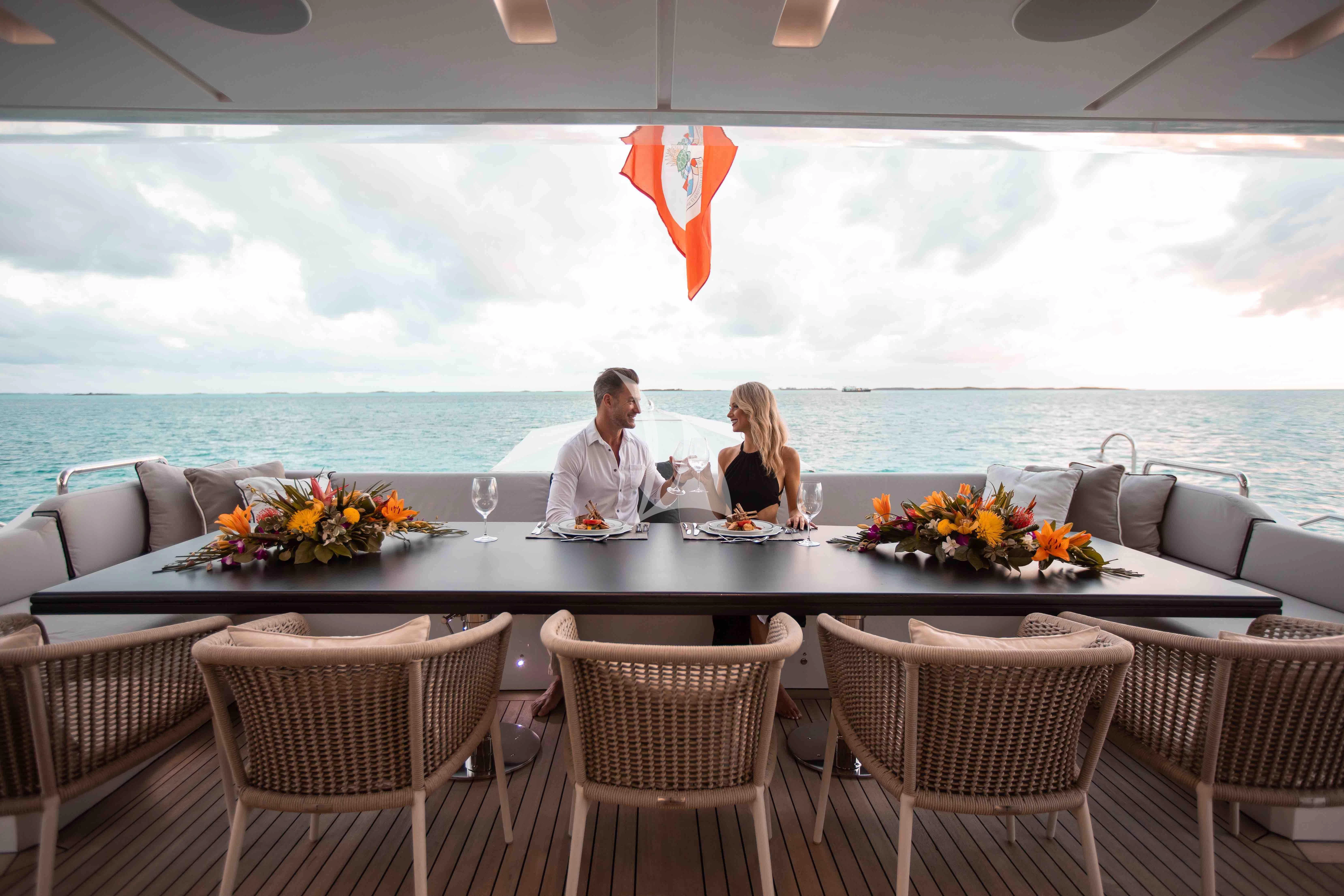 a couple sitting at a table aboard EMINA Yacht for Charter