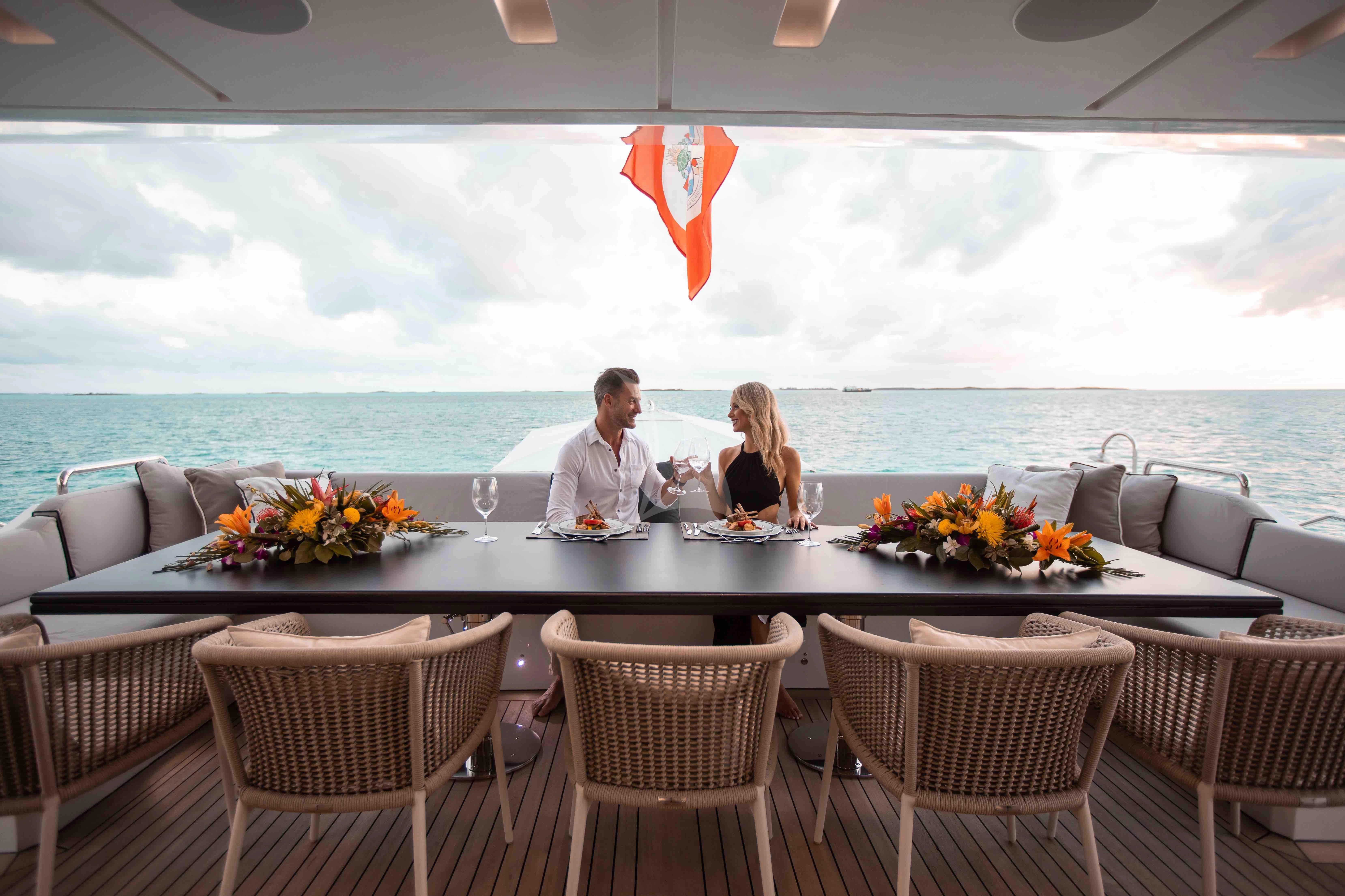 a couple sitting at a table aboard EMINA Yacht for Charter