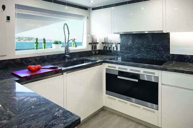 a kitchen with white cabinets aboard EMINA Yacht for Charter