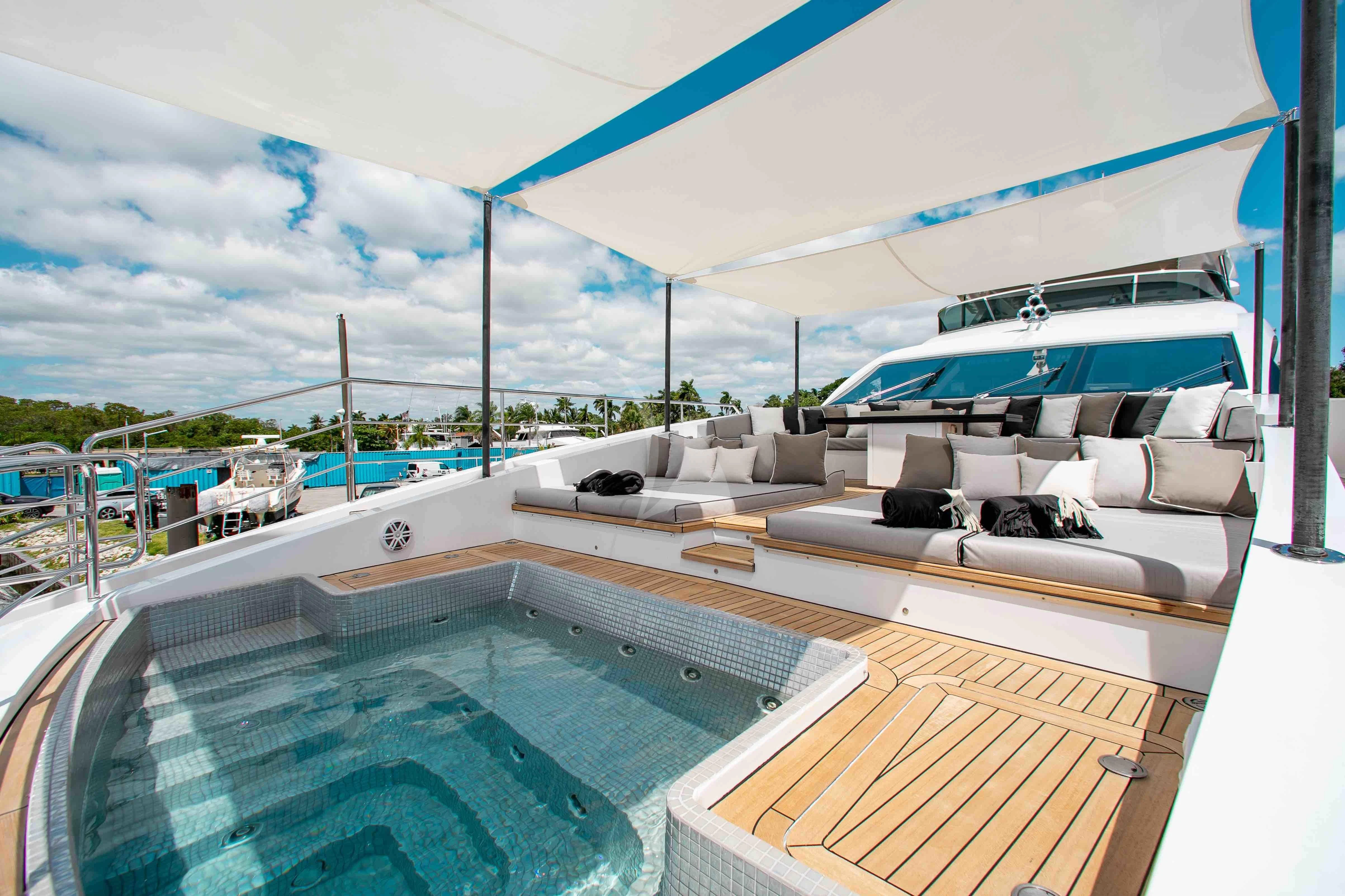 a deck with a pool and a deck with a view of the water aboard EMINA Yacht for Charter