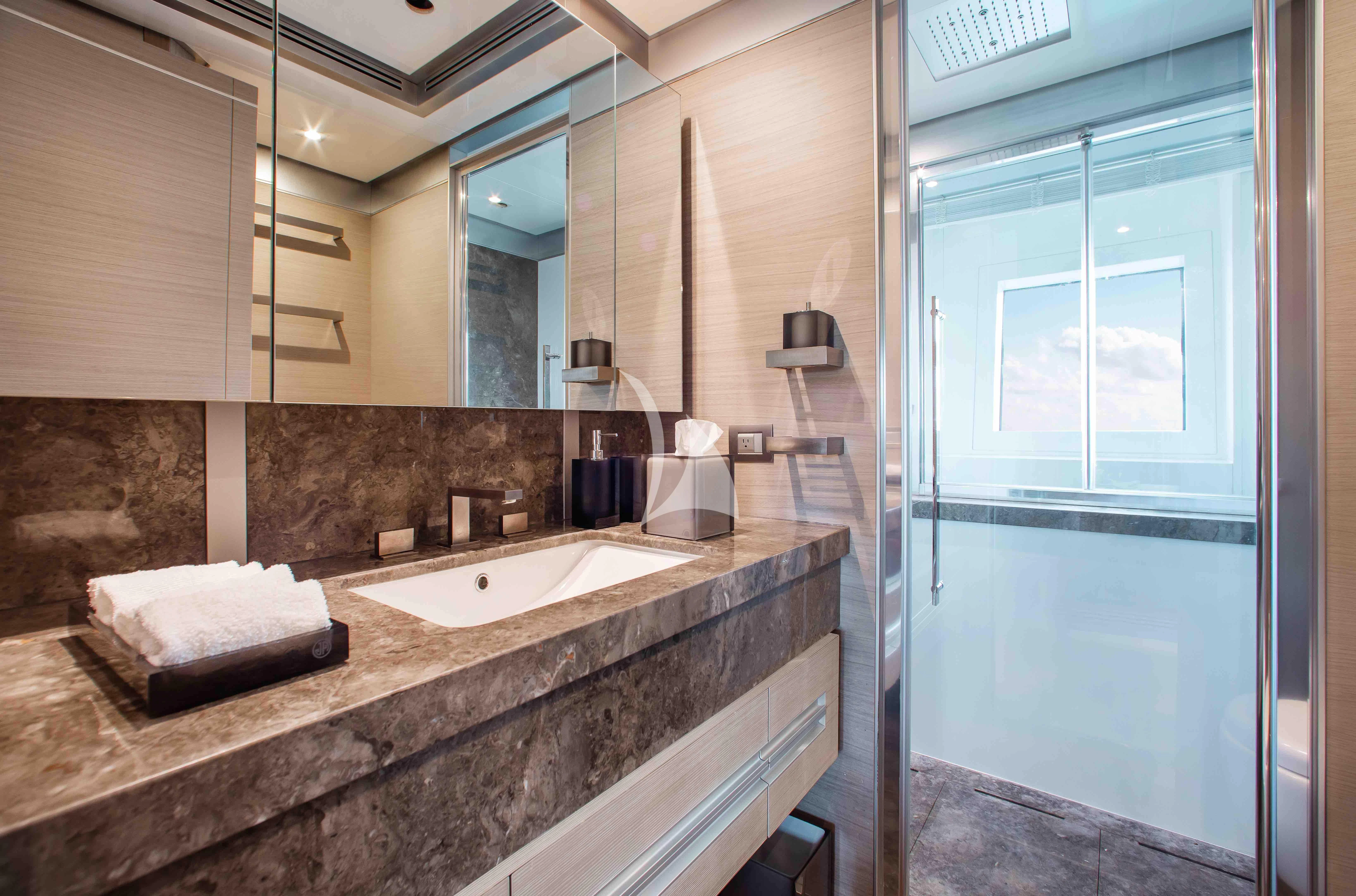 a bathroom with a countertop sink and a mirror aboard EMINA Yacht for Charter