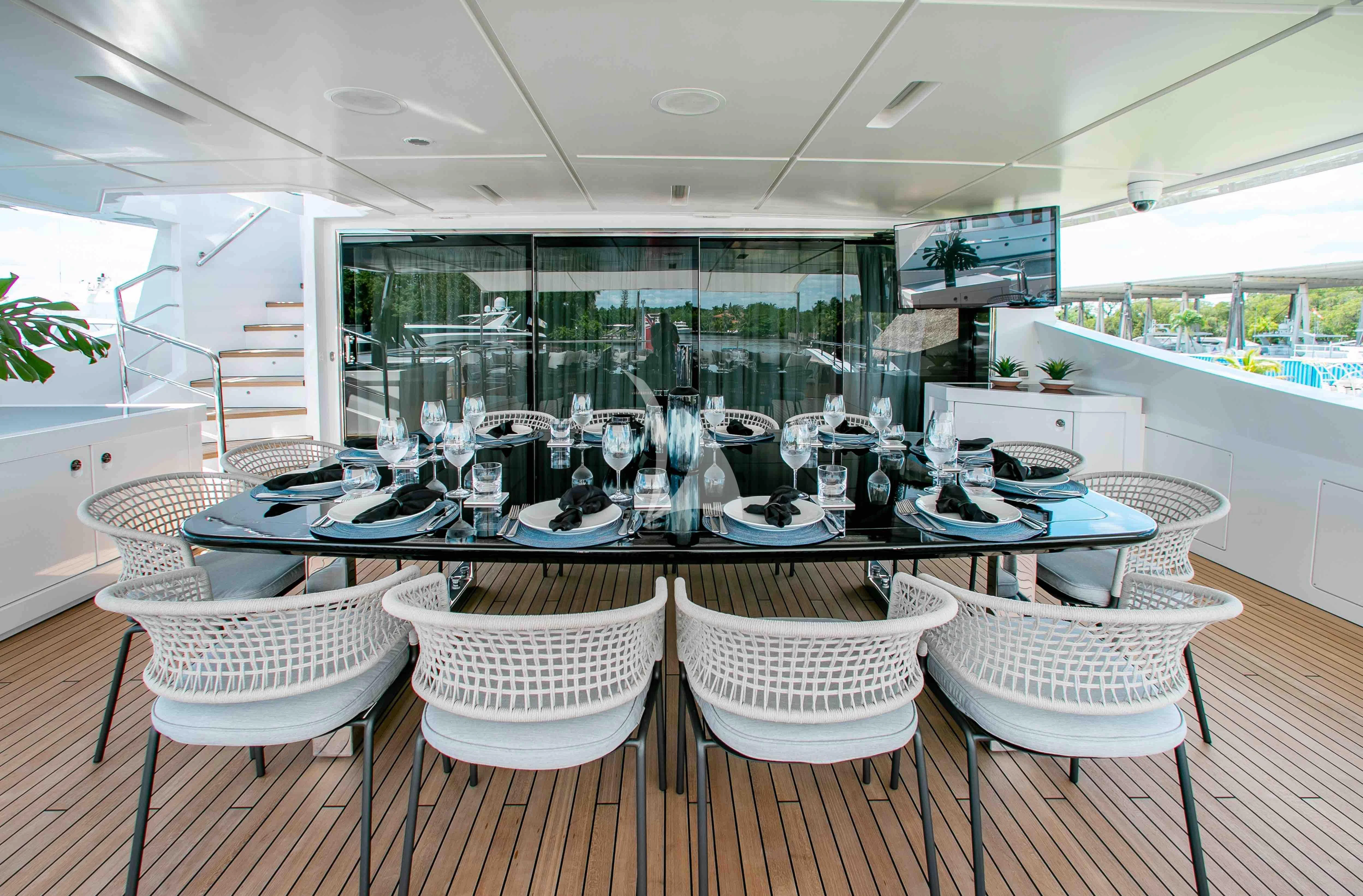 a table set for a dinner party aboard EMINA Yacht for Charter