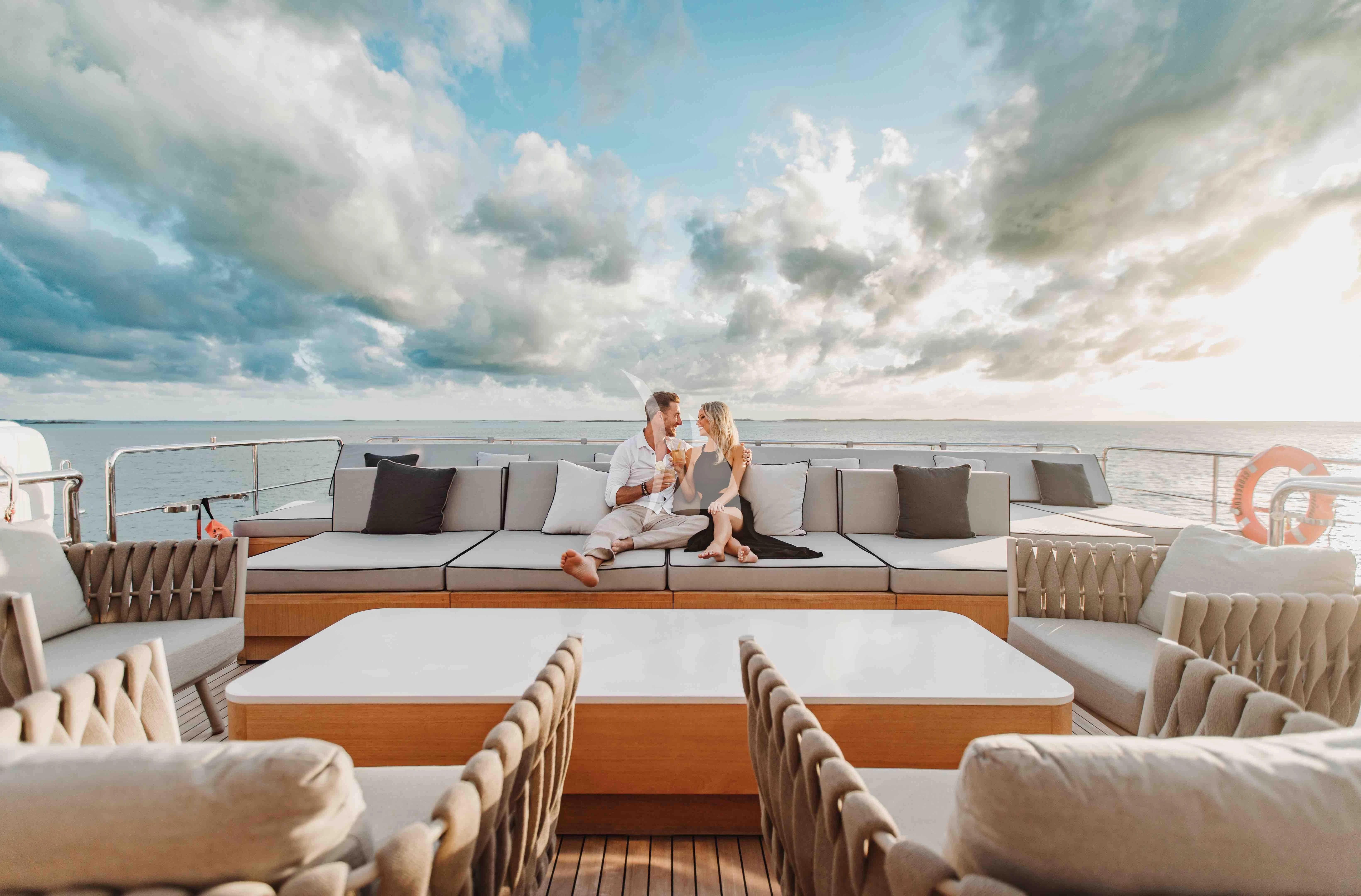 a group of people sitting on a couch on a boat aboard EMINA Yacht for Charter