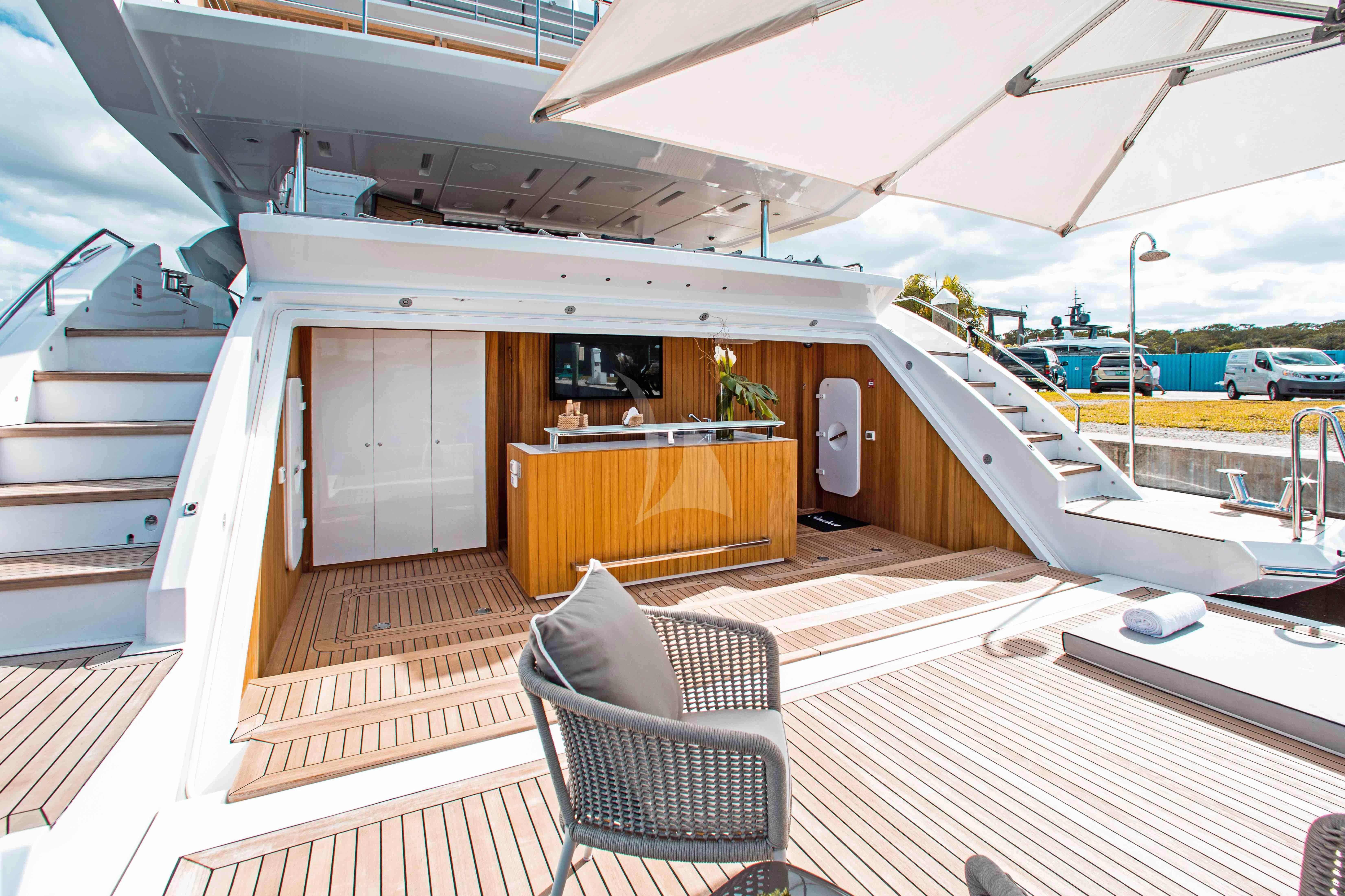 a deck with a chair and a table on it aboard EMINA Yacht for Charter