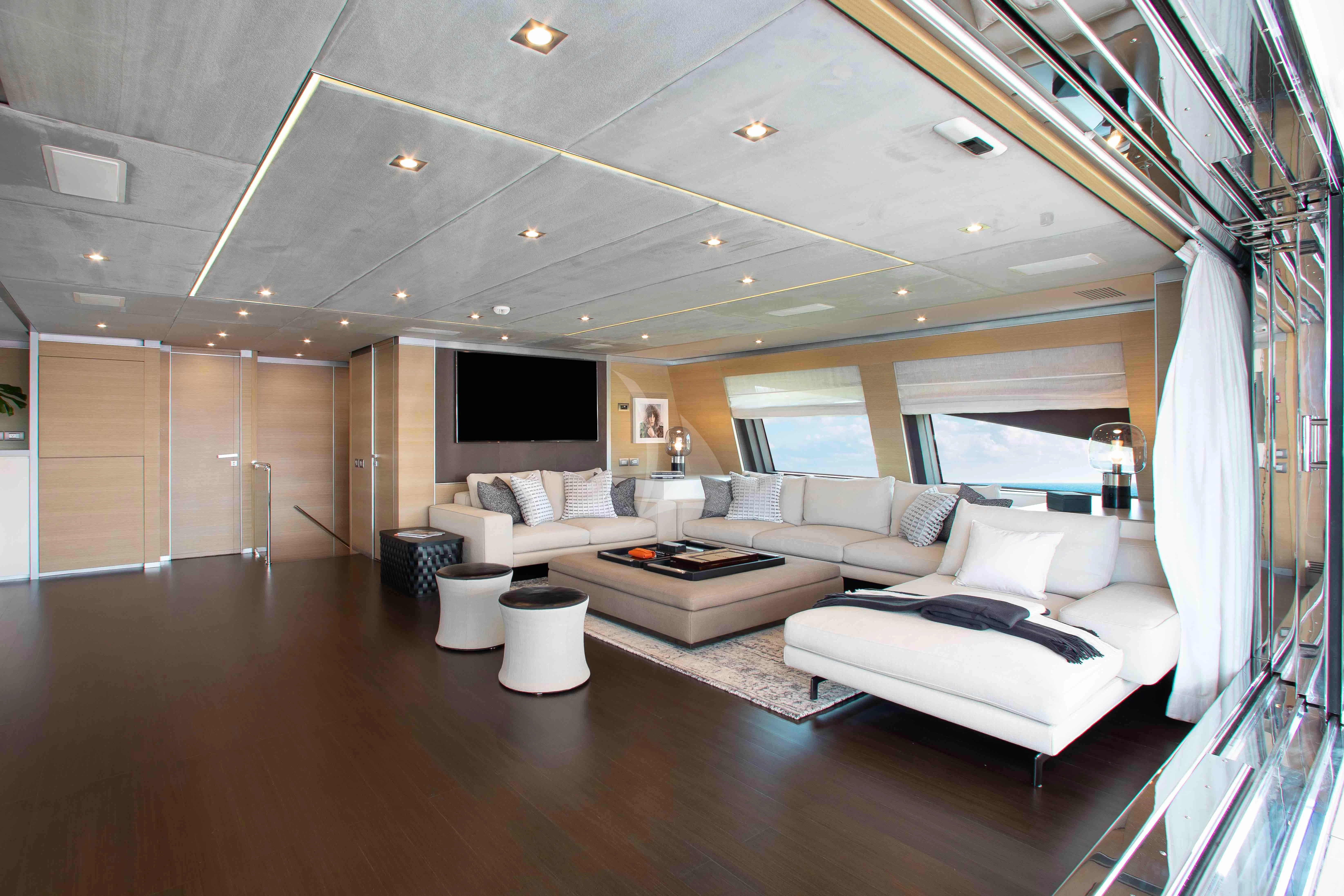 a large living room with a large window aboard EMINA Yacht for Charter