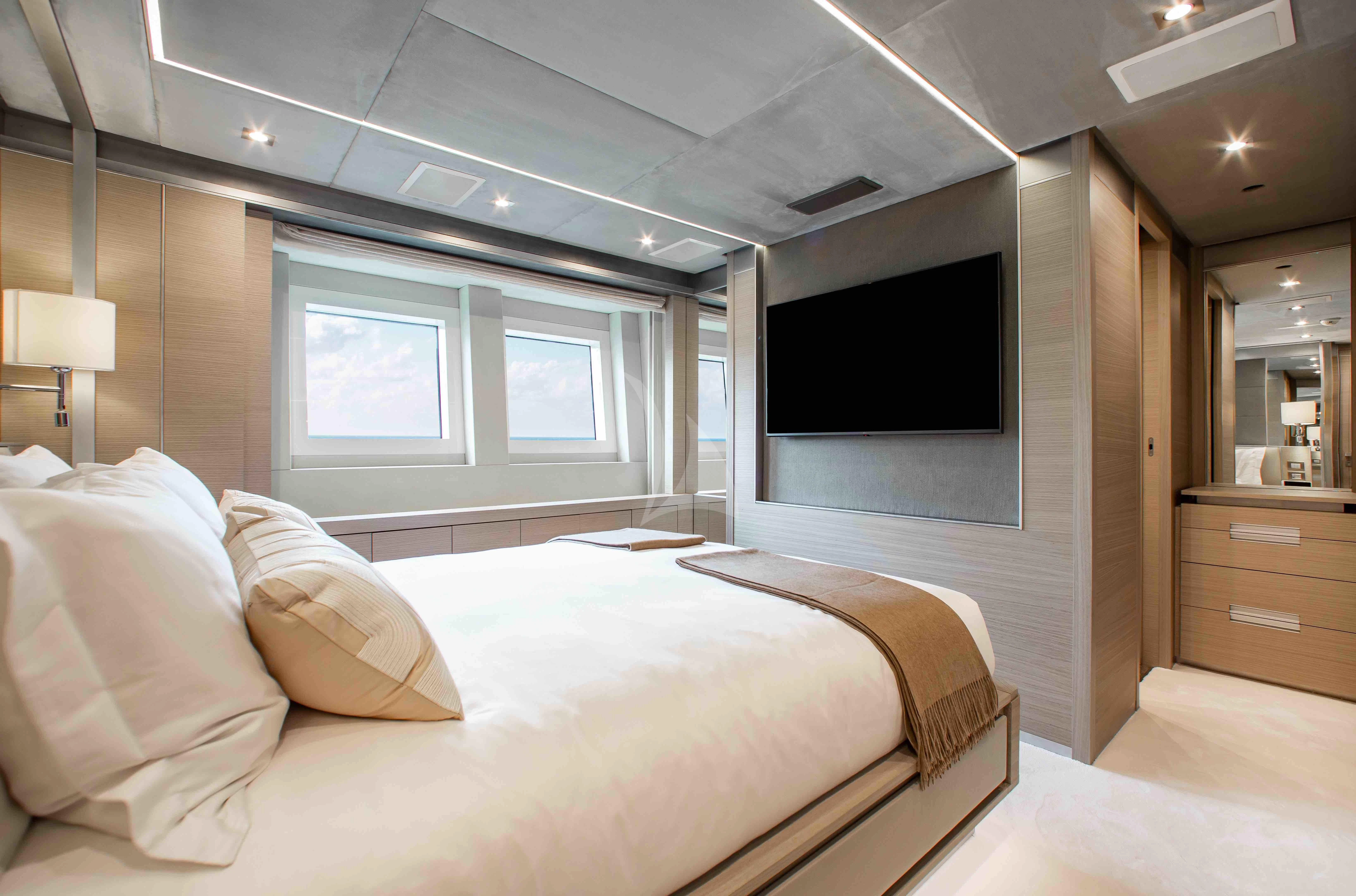 a bedroom with a bed and a tv aboard EMINA Yacht for Charter