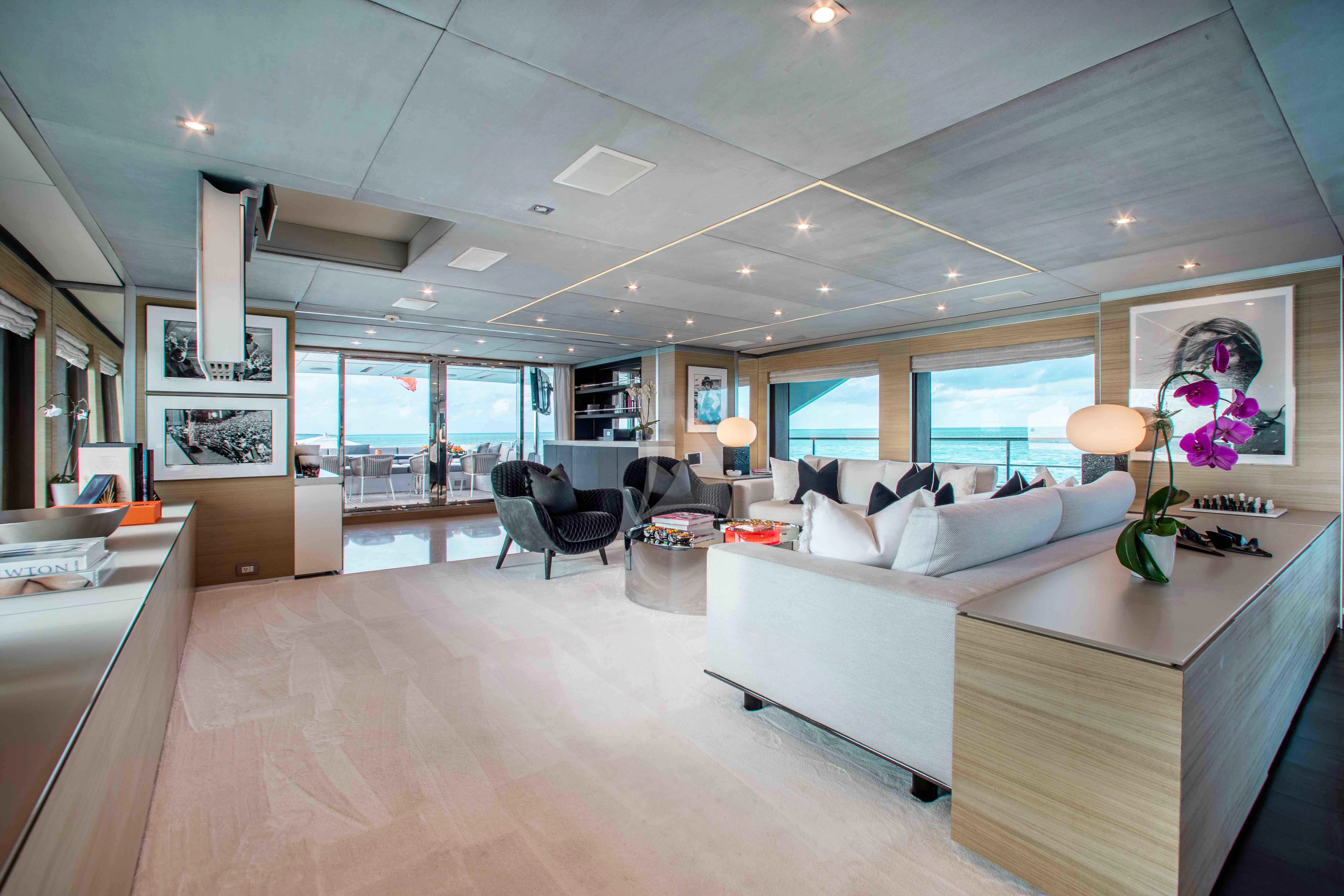 a large living room with a large window aboard EMINA Yacht for Charter