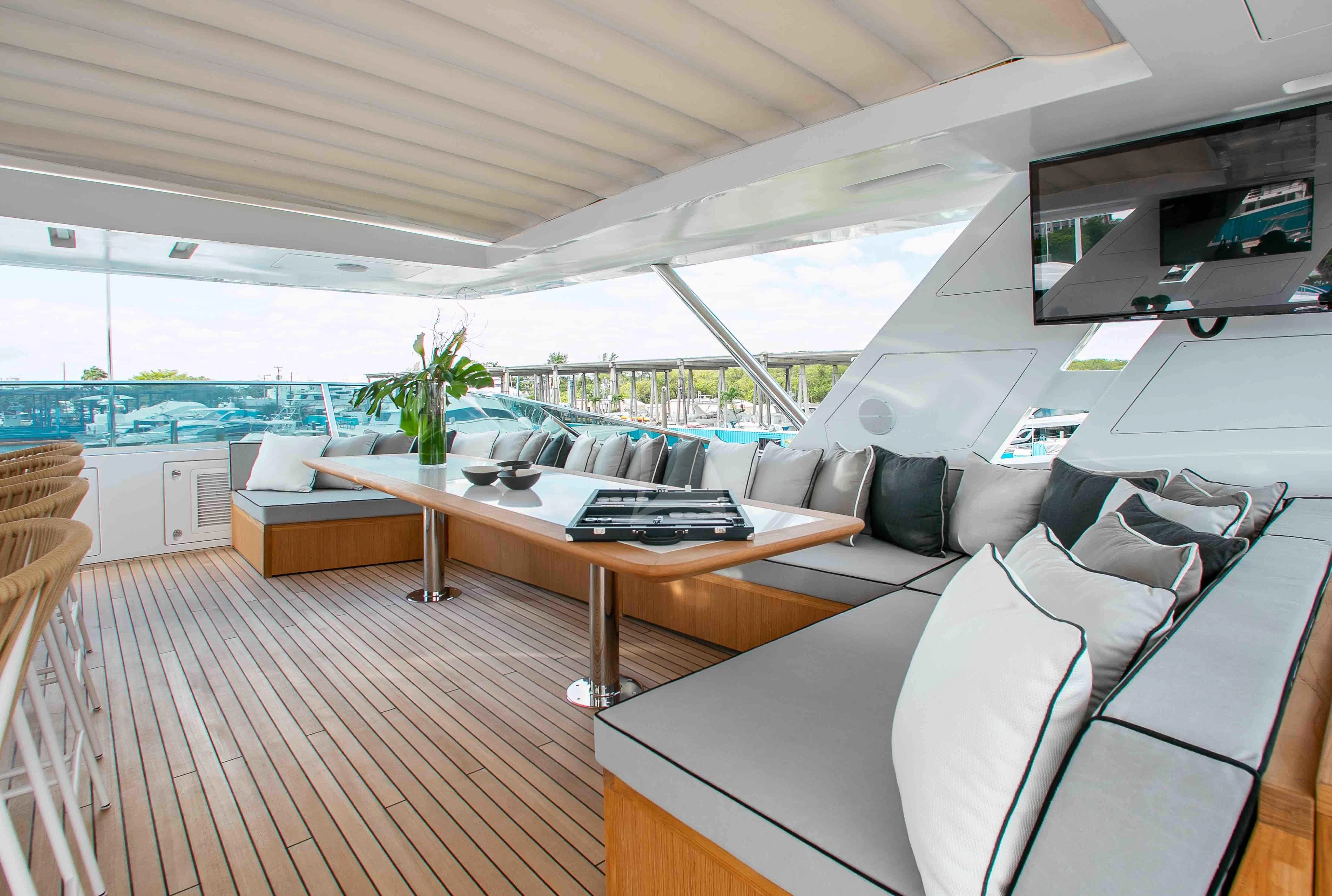 a room with a couch and a table with a laptop on it aboard EMINA Yacht for Charter