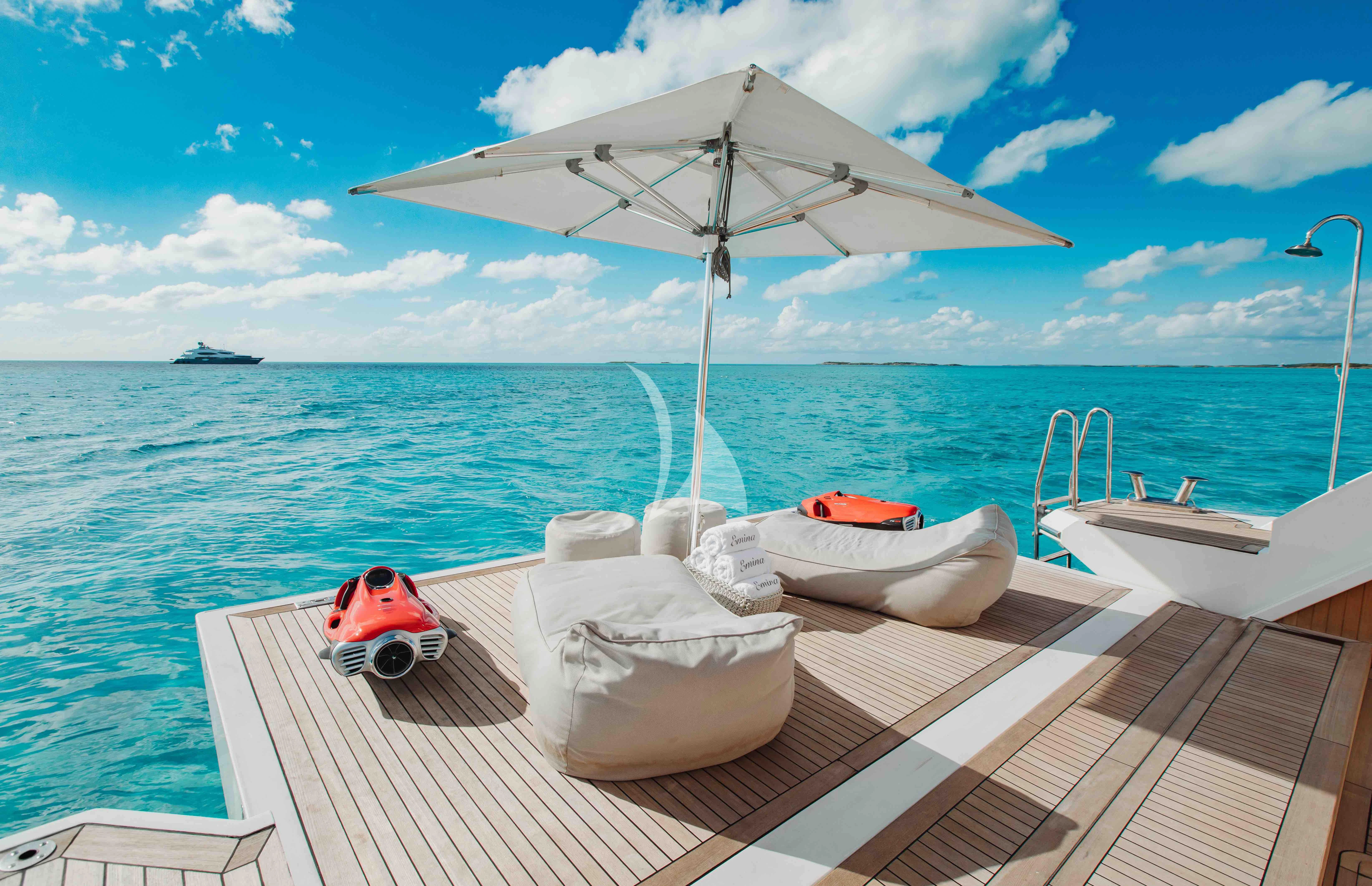 a boat with a white umbrella on it aboard EMINA Yacht for Charter
