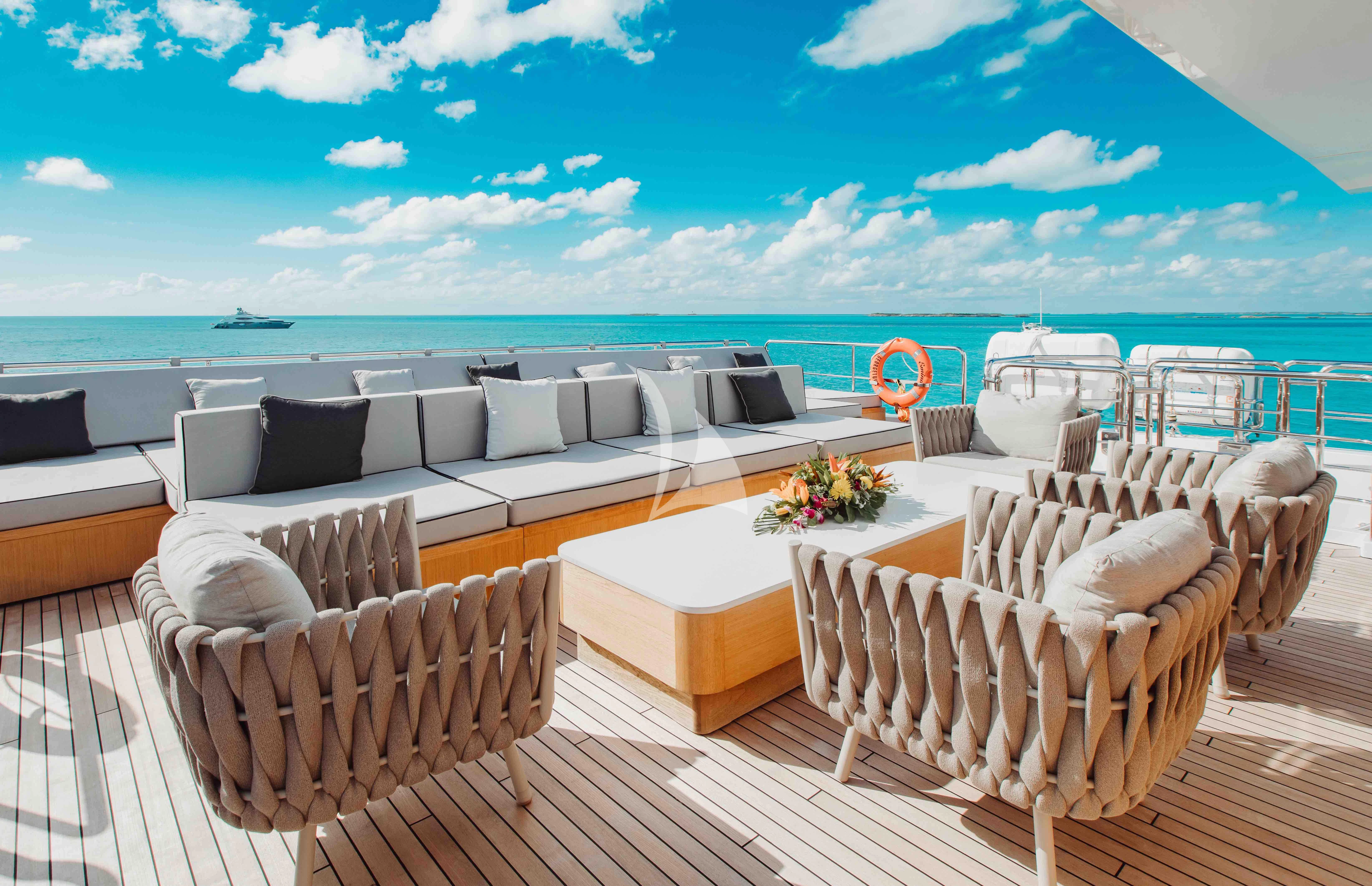 a deck with chairs and tables on it aboard EMINA Yacht for Charter
