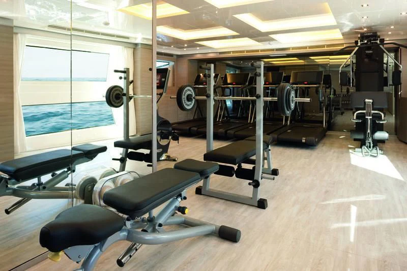 a gym with exercise equipment aboard EMINA Yacht for Charter
