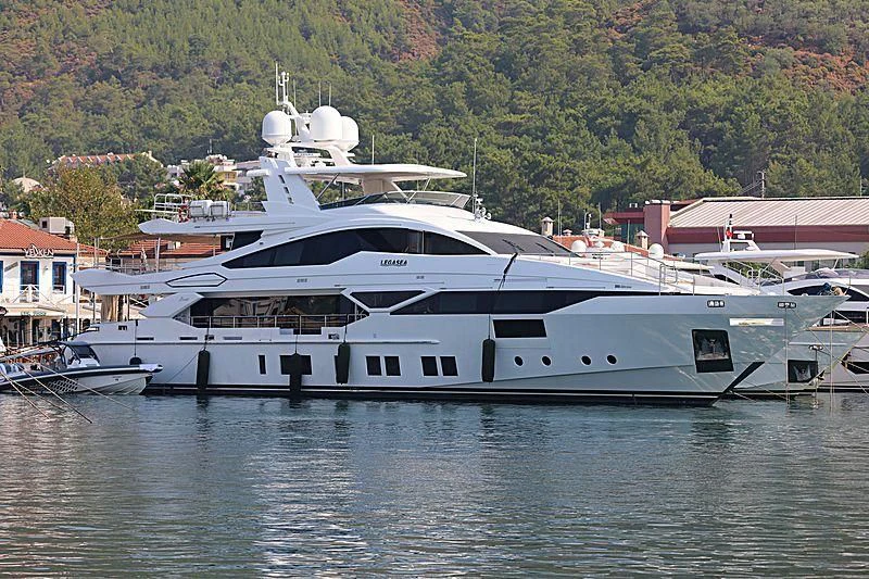 a large yacht docked at a pier aboard EMINA Yacht for Charter