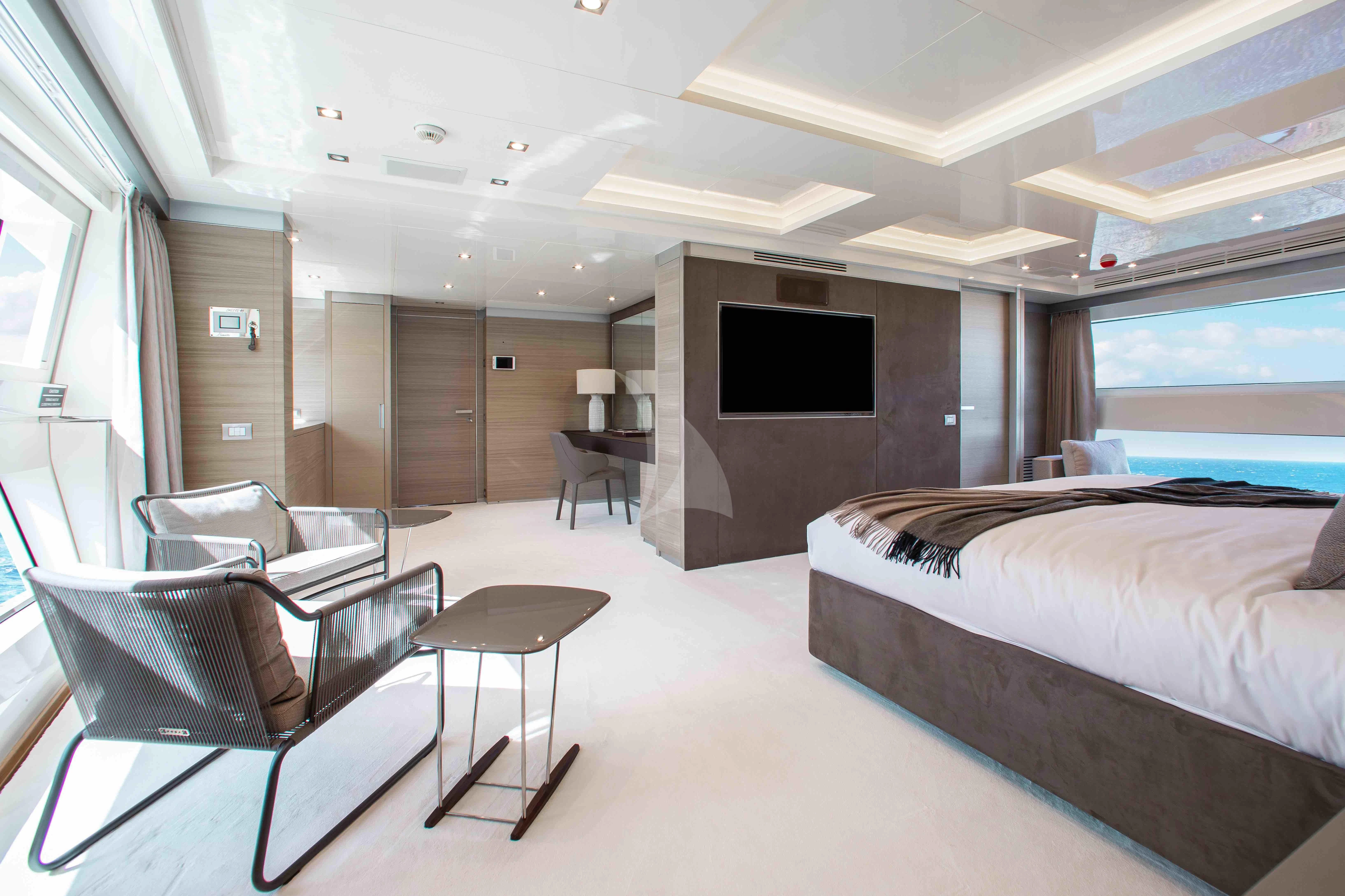 a room with a bed and a tv aboard EMINA Yacht for Charter