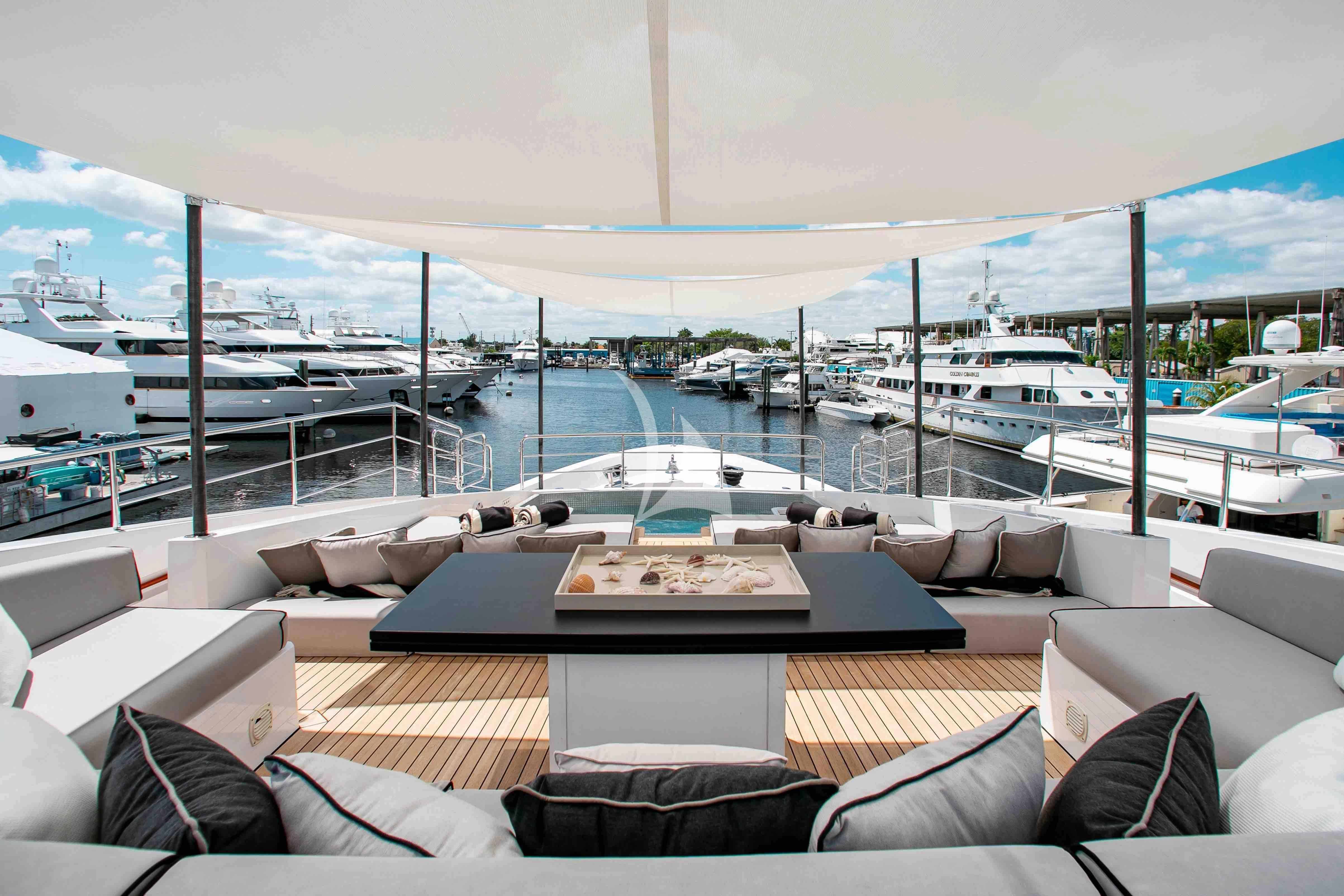a large lounge area with a view of the water and boats aboard EMINA Yacht for Charter