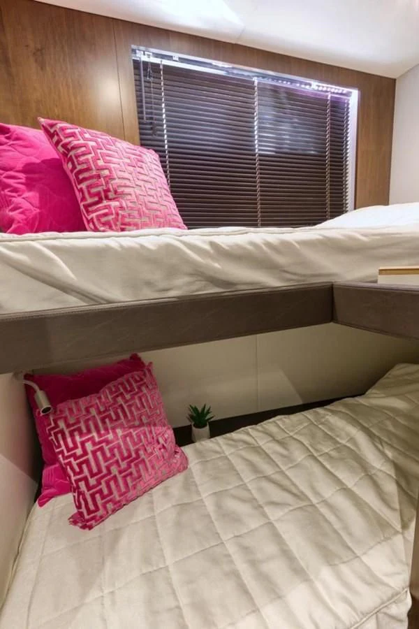 a bed with pillows and a window aboard LANA 1 Yacht for Sale