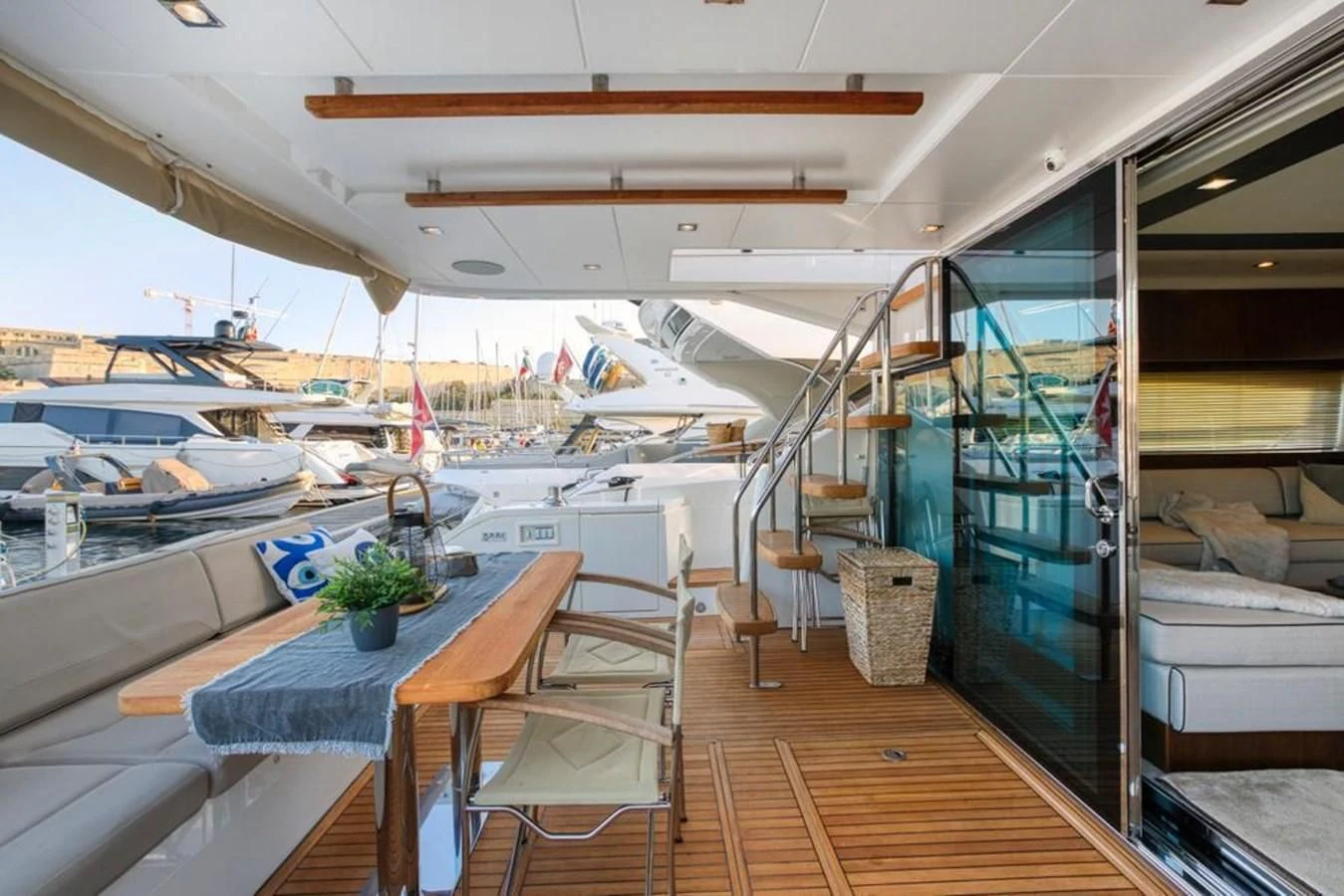 a boat with a table and chairs aboard LANA 1 Yacht for Sale