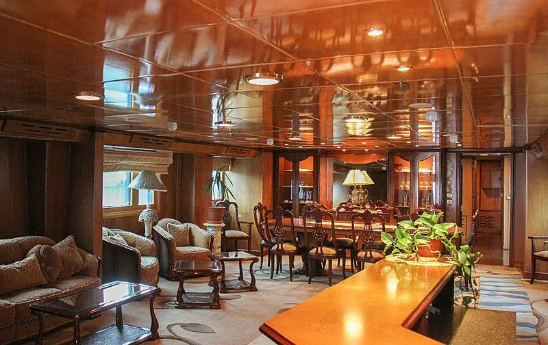 a large room with a table and chairs aboard PRINCESS OF PALAU Yacht for Sale